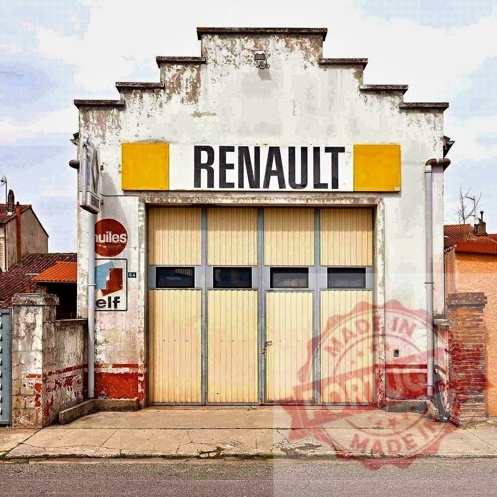 Abandoned Renault vintage garage building in France | Weathered facade of an old Renault garage with closed doors, showing disuse and nostalgia - Realisiert mit Pictrs.com