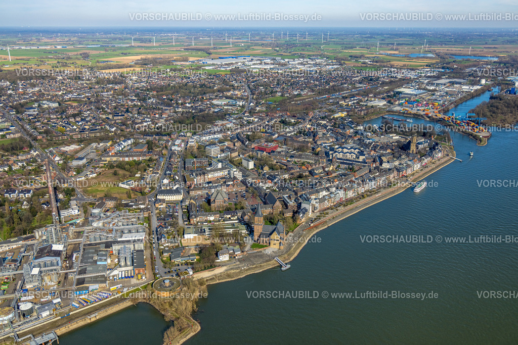 Emmerich240313246 | Luftbild, KLK Emmerich Chemiewerk, Stadtansicht und Rheinpromenade Fluss Rhein, Rathaus Stadtverwaltung am Geistmarkt, kath. Kirche St. Aldegundis und evang. Christuskirche und kath. Kirche St. Martini, Fernsicht mit Windräder im Hintergrund, Containerhafen, Emmerich, Emmerich am Rhein, Nordrhein-Westfalen, Deutschland