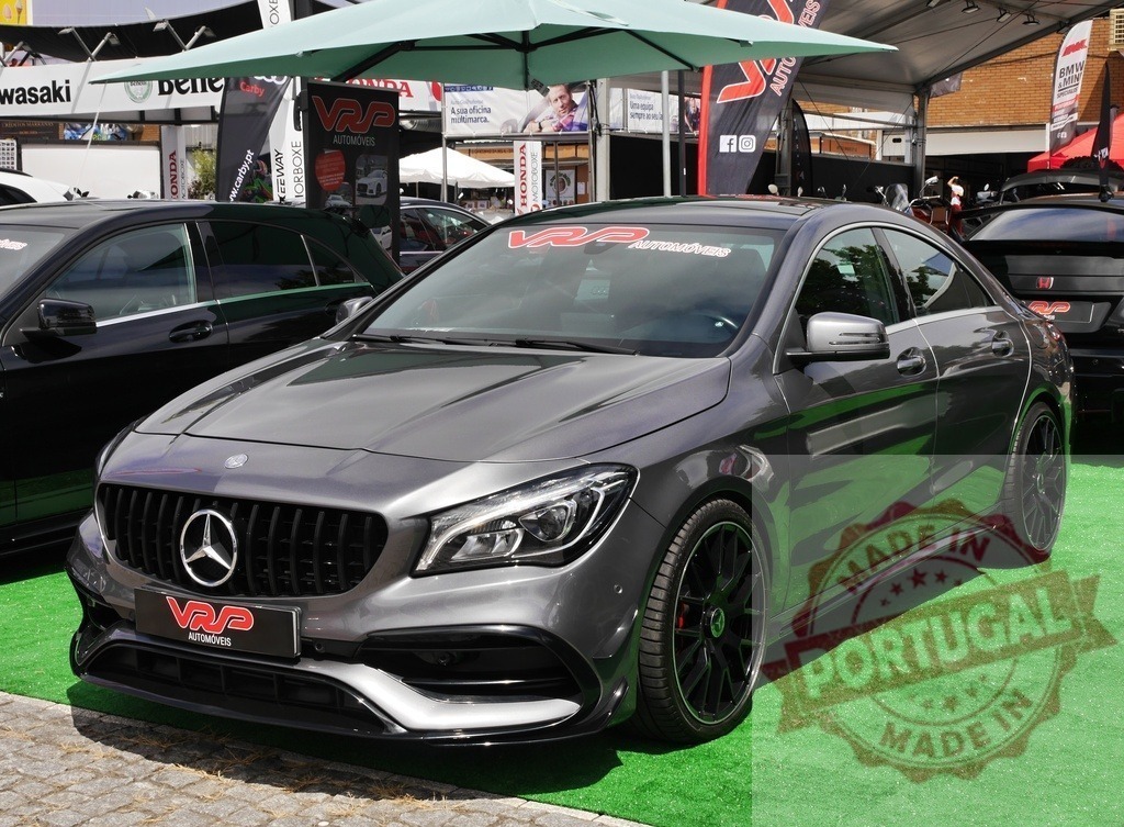 Mercedes-Benz CLA AMG sports sedan on display | Grey Mercedes-Benz CLA AMG sedan featuring VRP Automóveis branding at a car event - Realized with Pictrs.com