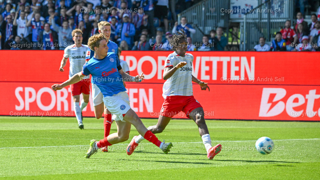 Holstein Kiel vs SC Freiburg | Lasse Rosenboom (Kiel #23) erzielt hier das 1-0 vs Johan Manzambi (Freiburg #44) / Fußball-Bundesliga Männer 2024/2025 / 33. Spieltag / Holstein Kiel vs SC Freiburg / Holstein-Stadion / Kiel / 10.05.25 - Realisiert mit Pictrs.com