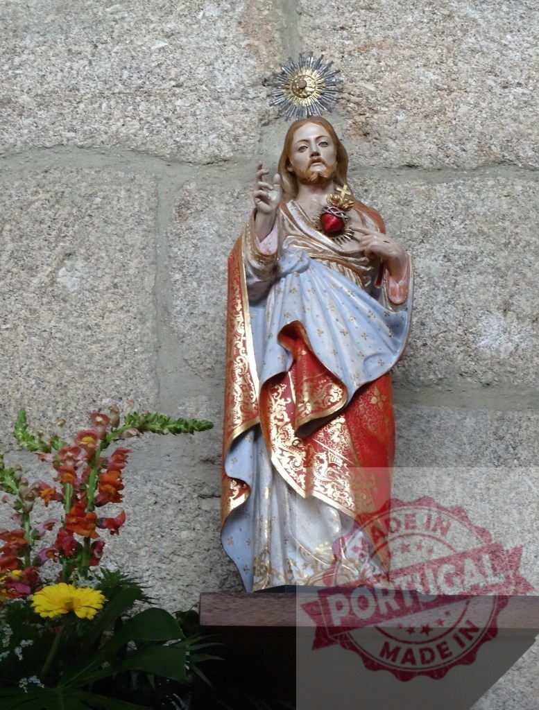 Sacred Heart of Jesus statue representing faith and devotion | Jesus Christ statue with Sacred Heart against a stone wall in a church, symbolizing spirituality - Realized with Pictrs.com