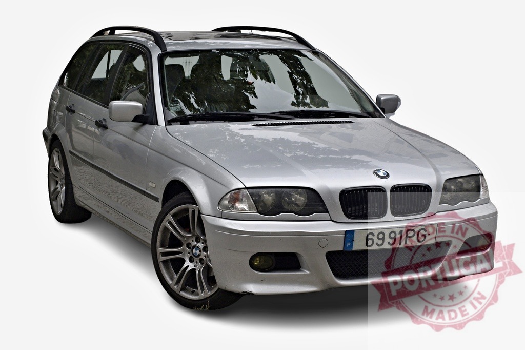 Silver BMW 3 Series Touring parked, showcasing its sleek design and roof rack | Stylish silver BMW 3 Series Touring parked, emphasizing its elegant design, alloy wheels, and practical roof rack - Realized with Pictrs.com