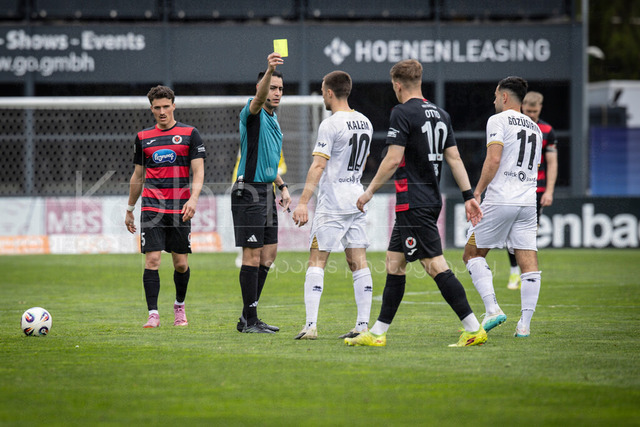 Viktoria Koeln vs. SV Wehen Wiesbaden, 11.04.2026 | KOELN, GERMANY - APRIL 11, 2026:  referee Cengiz Kabalakli (Gelsenkirchen) shows Robin Kalem (SV Wehen Wiesbaden, 10) the yellow card after a foul during the 3rd division match between Viktoria Koeln vs. SV Wehen Wiesbaden at the Sportpark Hoehenberg on matchday 7 on April 11, 2026 in Koeln, Germany. DFL REGULATIONS PROHIBIT ANY USE OF PHOTOGRAPHS AS IMAGE SEQUENCES AND/OR QUASI-VIDEO.