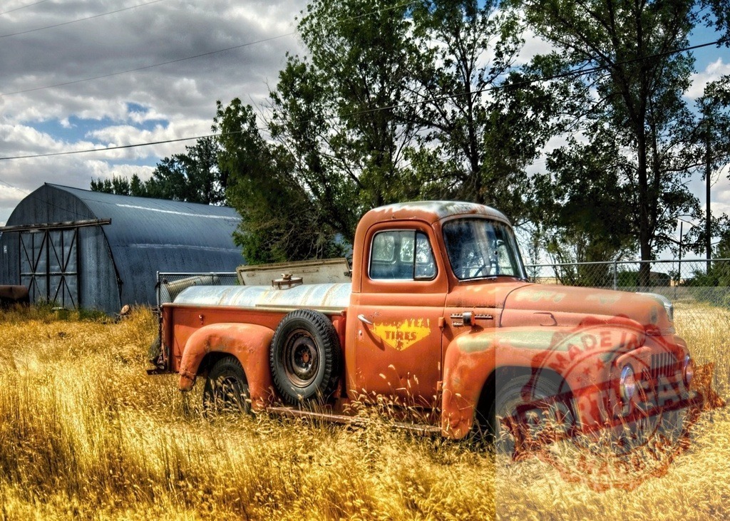 Abandoned rusty vintage truck in golden field | Old orange International Harvester truck rusting in a field of golden dry grass on a farm - Realized with Pictrs.com