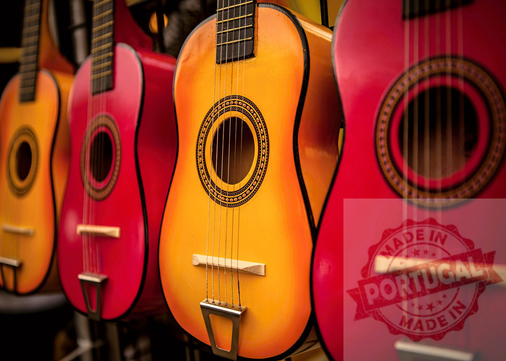 Colorful guitars hanging in a music store, waiting for musicians | Vibrant display of colorful guitars in a music shop, ready to be played - Realized with Pictrs.com