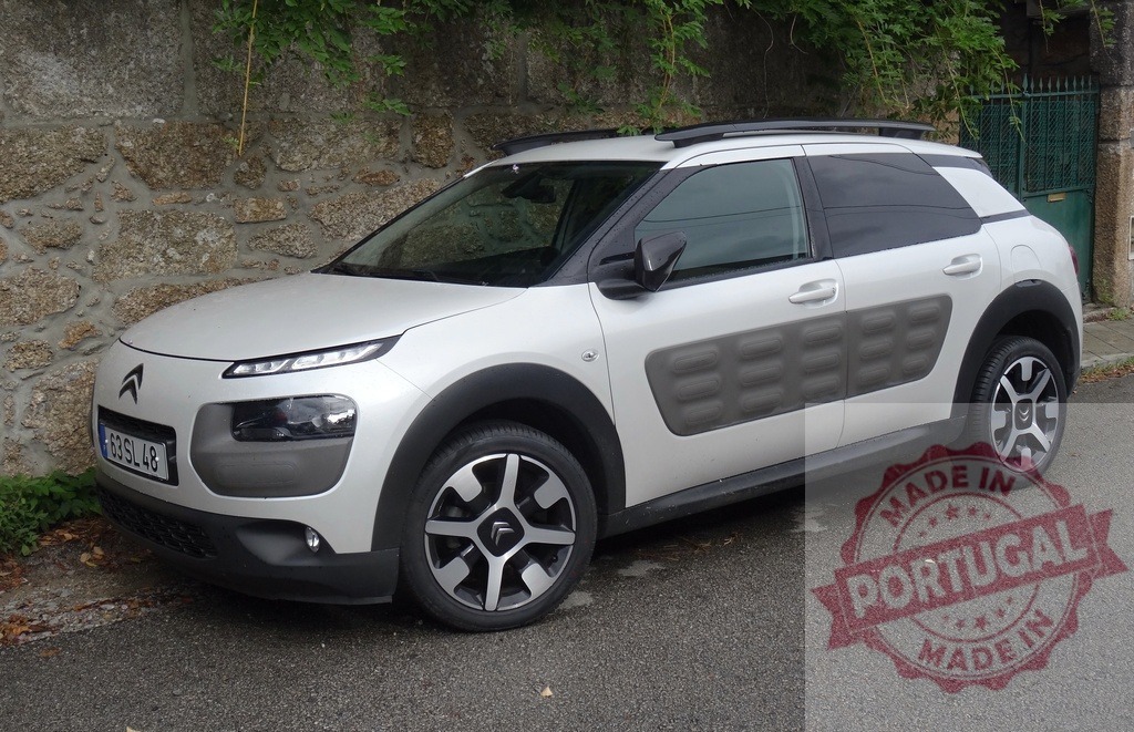 Citroën C4 Cactus parked on asphalt street | White Citroën C4 Cactus compact crossover parked next to stone wall on a residential street - Realisiert mit Pictrs.com