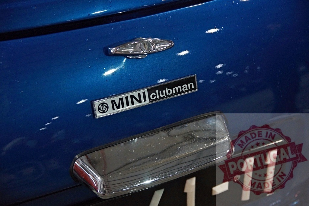 Vintage Mini Clubman car detail showing Leyland badge | Blue classic Mini Clubman car exterior showing chrome badge and logo - Realized with Pictrs.com