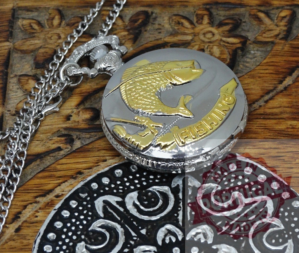 Engraved pocket watch with fishing theme on wood | Metallic pocket watch with a gold fish and fishing word on a carved wooden surface - Realized with Pictrs.com