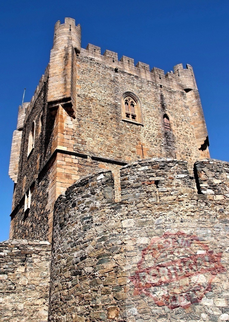 Bragança Castle medieval fortress tower reaching blue sky. Region Norte - Portugal | Bragança Castle medieval tower and stone walls against a clear blue sky - Realized with Pictrs.com