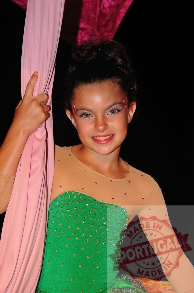 Young aerial performer posing with pink silk fabric on stage | Young circus performer in bright costume smiling while holding aerial silk - Realized with Pictrs.com