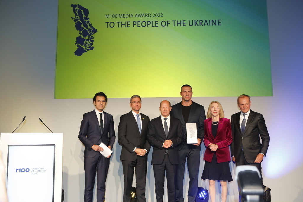 M100 Media Award: „Preis der europäischen Presse“ in Potsdam für das Ukrainische Volk verliehen. | Mit dem M100 Media Award, der sich als „Preis der europäischen Presse“ versteht, wird in diesem Jahr das Ukrainische Volk ausgezeichnet. Die Auszeichnung nimmt stellvertretend Wladimir Klitschko in der Orangerie im Park Sanssouci entgegen. Das Bild zeigt Mike Schubert, Olaf Scholz,Wladimir Klitschko, US-Botschafterin Amy Gutmann und Donald Tusk.