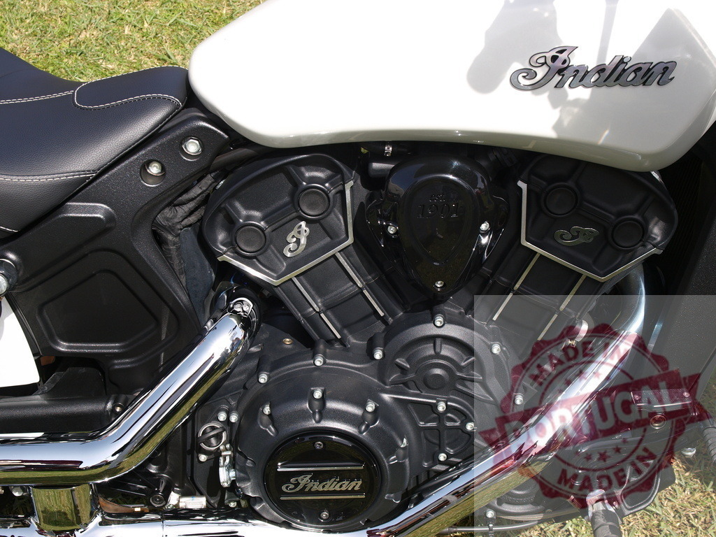 Indian Motorcycle Scout V-twin engine detail with chrome exhaust | Indian Scout motorcycle's powerful V-twin engine showcasing chrome components and brand logo - Realisiert mit Pictrs.com