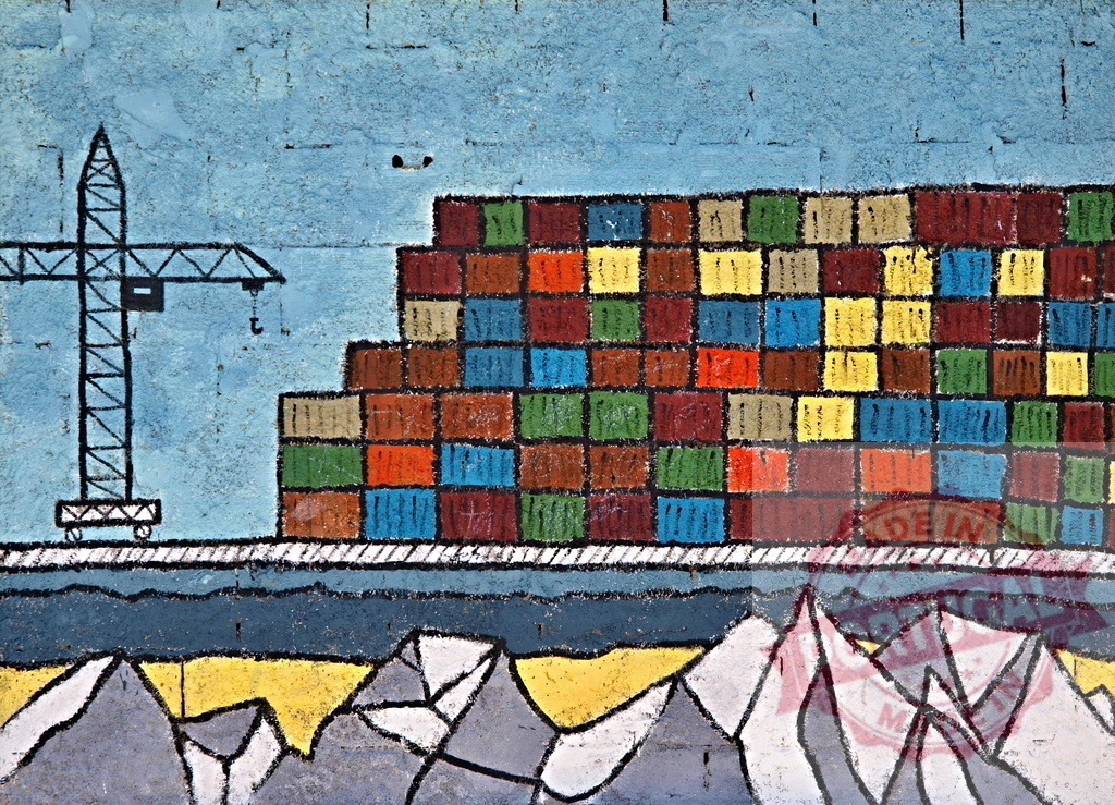 Crane loading colorful cargo containers on a ship sailing near snowy mountains, global trade and logistics concept | Colorful mural depicting a crane loading cargo containers on a ship sailing near snowy mountains, symbolizing global trade and logistics - Realisiert mit Pictrs.com
