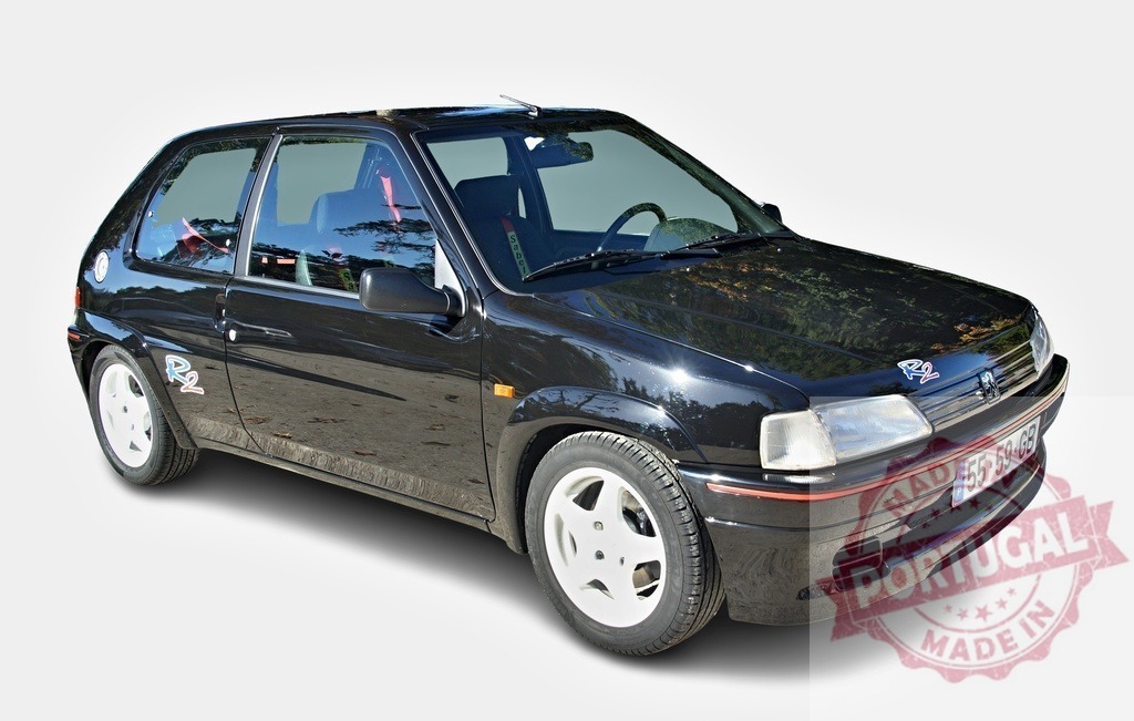 Peugeot 106 R2 black rally car hatchback | Black Peugeot 106 R2 rally car with Sabelt racing seatbelt, isolated - Realized with Pictrs.com