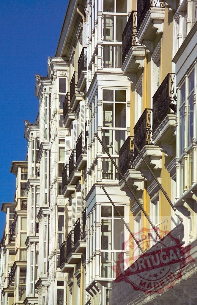 Coruña glass galleries and balconies architecture. Spain - Cantabria | Row of historic white facades showcasing traditional glass galleries and balconies - Realized with Pictrs.com