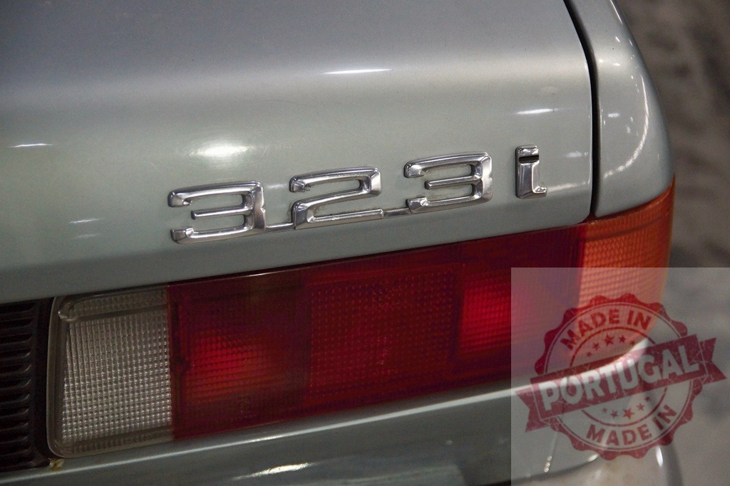 BMW 323i car emblem and taillight close-up | Classic BMW 323i automobile trunk showing model emblem and rear taillight - Realisiert mit Pictrs.com