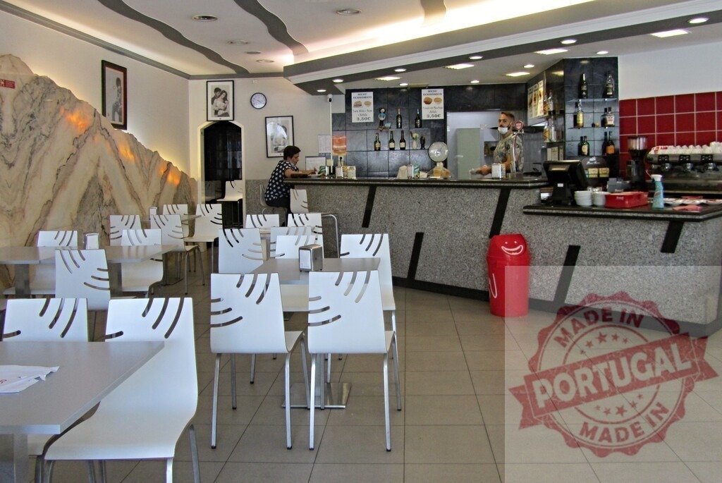 People relaxing in a modern cafe bar interior | Modern cafe interior with empty tables, chairs, and bar counter, a waiter serving a customer - Realized with Pictrs.com