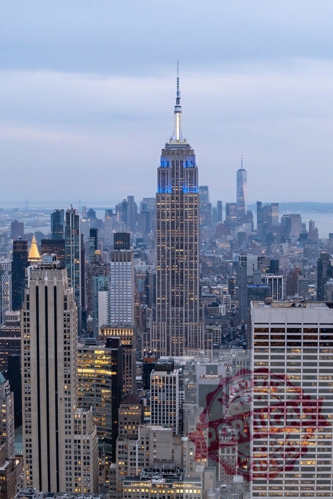 Empire State Building dominating New York City skyline during twilight | The majestic Empire State Building stands tall amidst the illuminated cityscape of New York City at twilight - Realized with Pictrs.com
