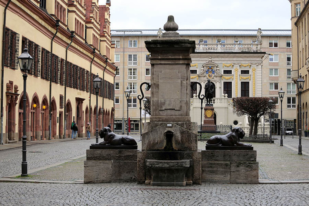 Foto: Leipzig - Löwenbrunnen auf dem Naschmarkt - Blick zur Alten Handelsbörse | Das Team hinter BILDLEXIKON LEIPZIG bündelt historische wie aktuelle Informationen über die Stadt Leipzig in Text und Bild auf einer Plattform und stellt diese der interessierten Öffentlichkeit zur Verfügung.