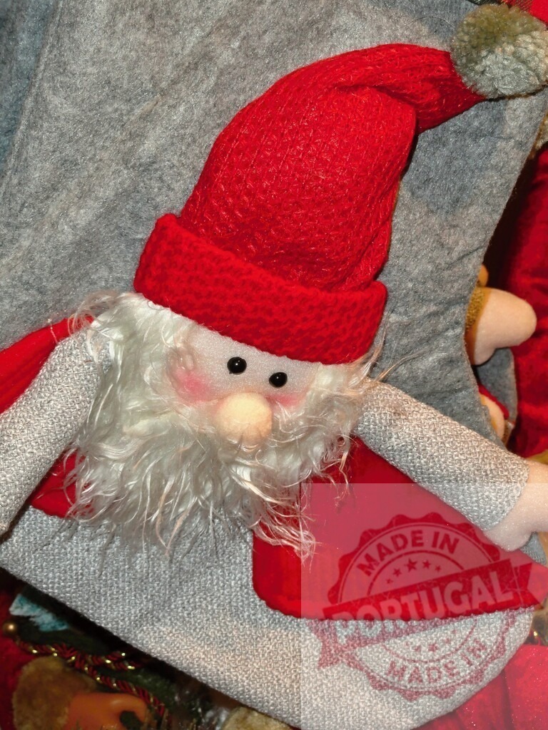 Christmas stocking with santa claus figure wearing red hat and gray clothes | Christmas stocking with santa claus figure wearing red hat and gray clothes, waiting to be filled with gifts - Realized with Pictrs.com