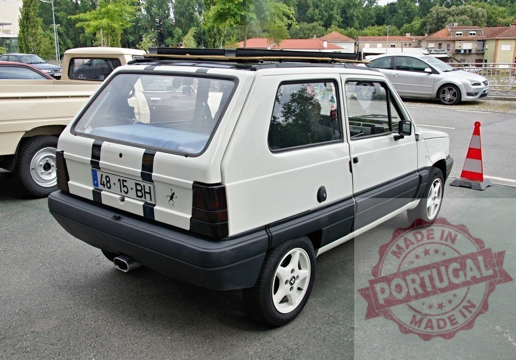 SEAT Marbella vintage car displaying custom stripes | SEAT Marbella vintage hatchback showing customized rear design and roof rack - Realized with Pictrs.com