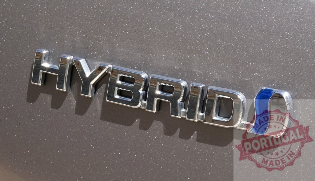 Hybrid car chrome emblem detail showcasing sustainable technology | Chrome HYBRID emblem on a car's painted surface, symbolizing eco-friendly energy - Realized with Pictrs.com