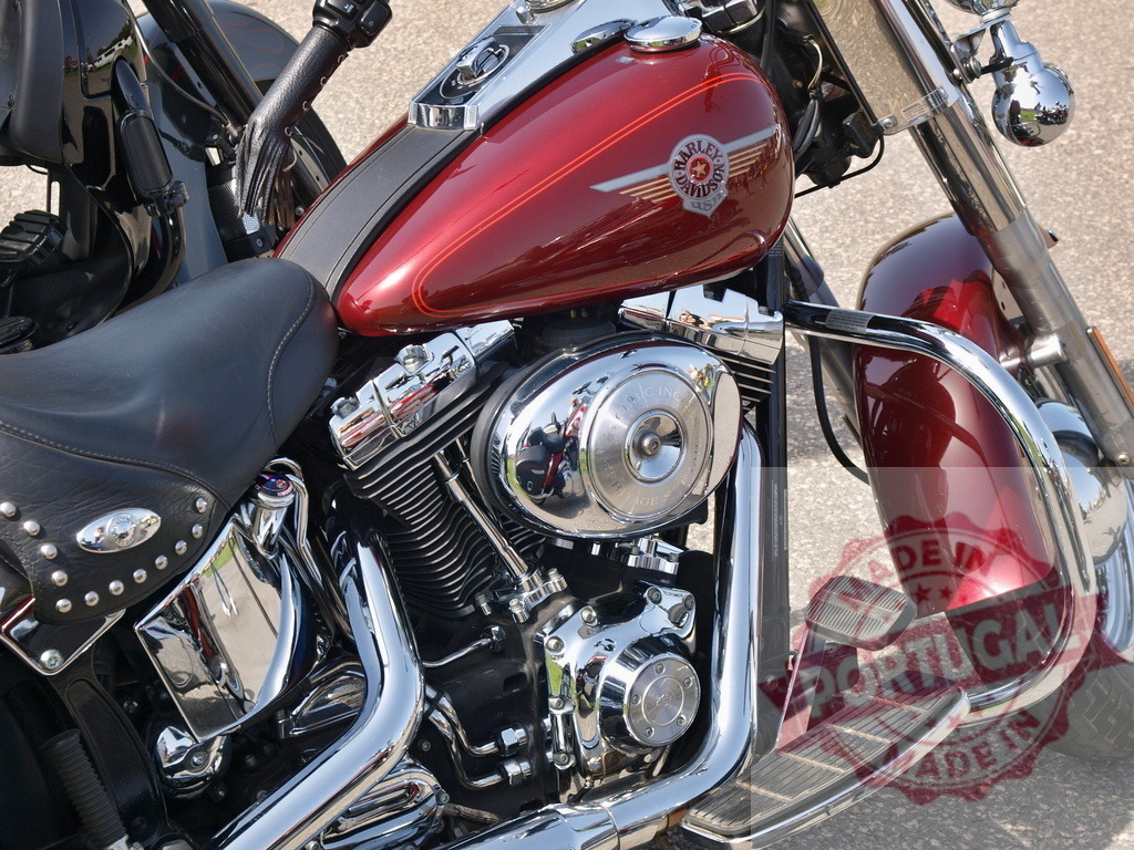 Harley-Davidson motorcycle with gleaming chrome and red paint | Harley-Davidson cruiser motorcycle with a red fuel tank, chrome engine parts, and black leather seat - Realized with Pictrs.com
