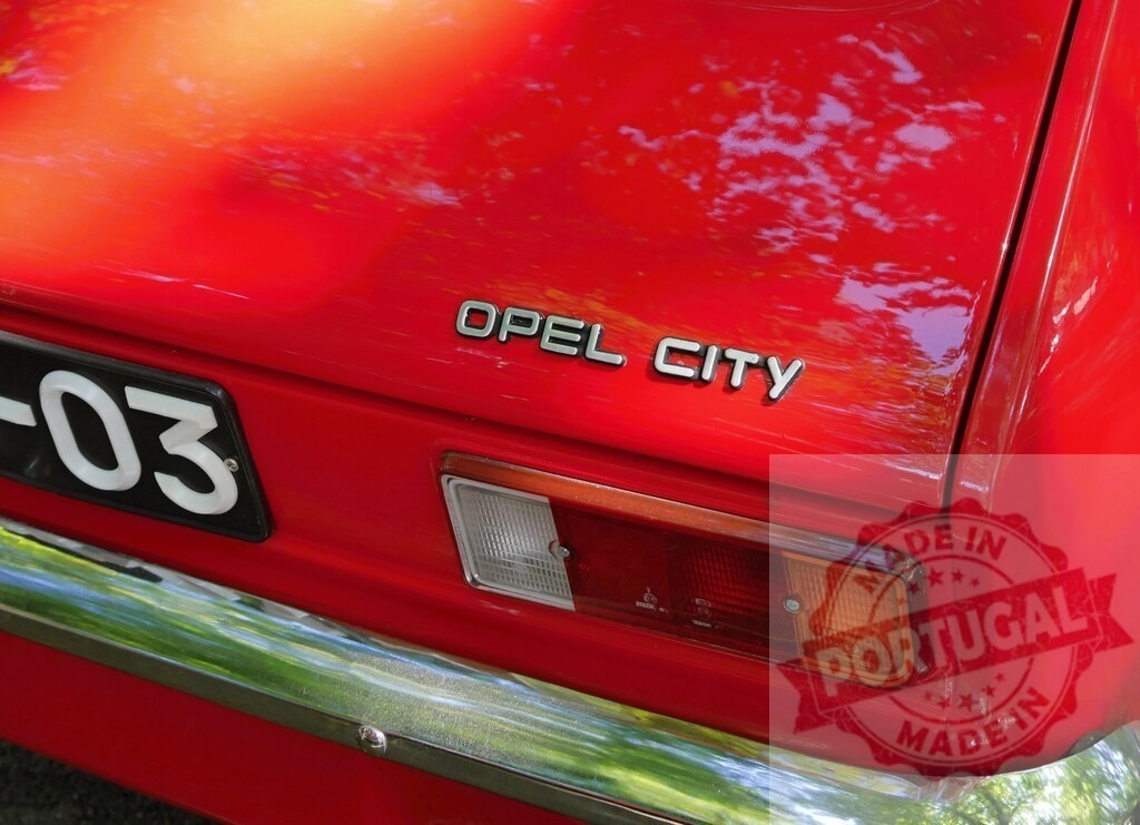 Opel City classic car rear view details | Opel City emblem and taillight on a red vintage car rear - Realized with Pictrs.com
