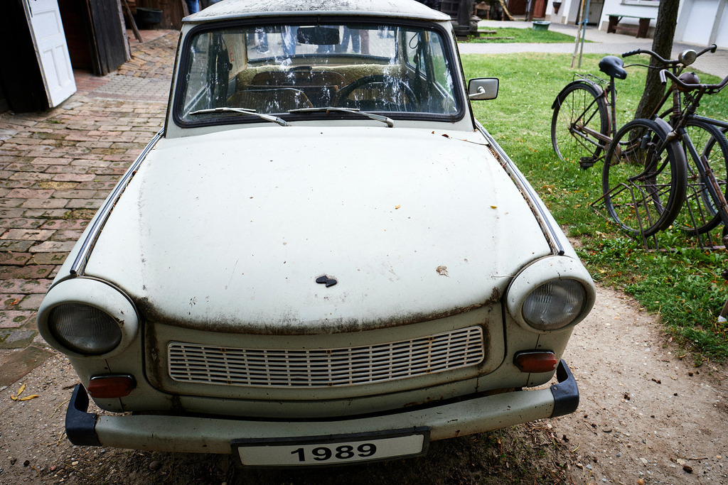 Trabi steht vor der Zollstation | Mönchhof, Austria - October 06, 2021: Dorfmuseum Mönchhof; Trabi steht vor der Zollstation mit Fahrräder im Hintergrund. - Realisiert mit Pictrs.com