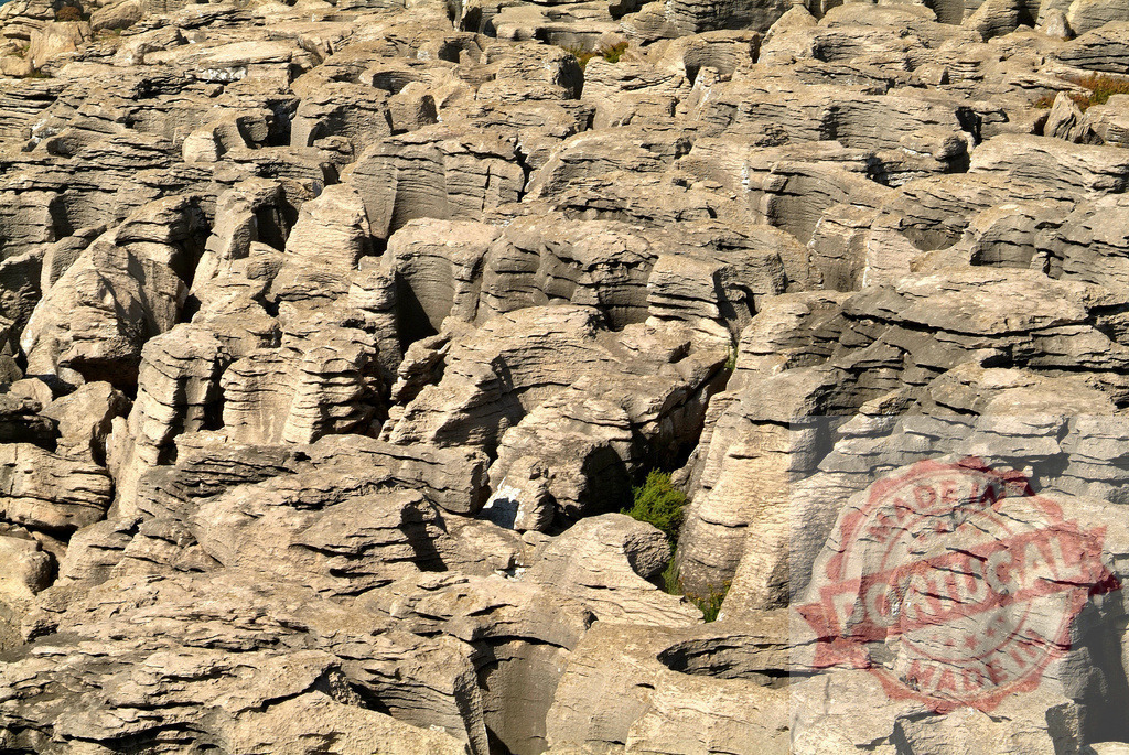 Eroded limestone rock formations creating abstract patterns. Centro Portugal | Intricate natural erosion forming textured patterns in limestone landscape - Realized with Pictrs.com