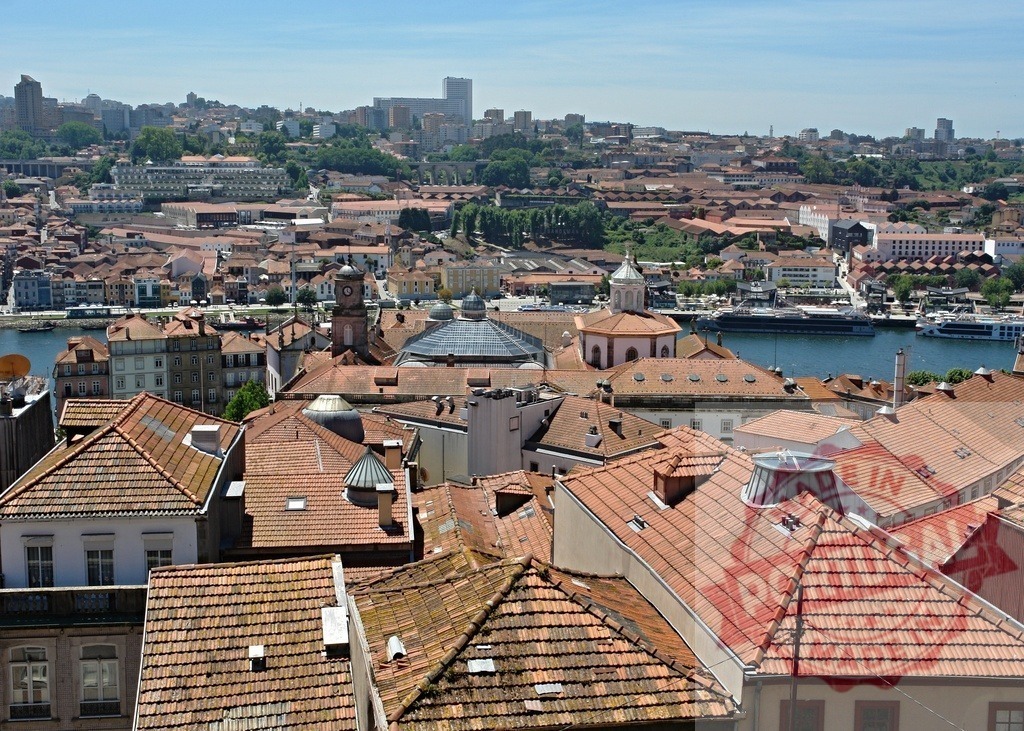 Porto city view seeing Douro river and red roofs | Porto cityscape with old town buildings and Douro river on a sunny day - Realized with Pictrs.com