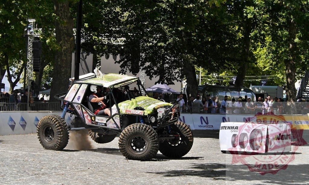 Pilot driving a buggy during an off-road competition in urban environment | Pilot driving a buggy during an off-road car competition in urban environment, drifting and making dust - Realized with Pictrs.com
