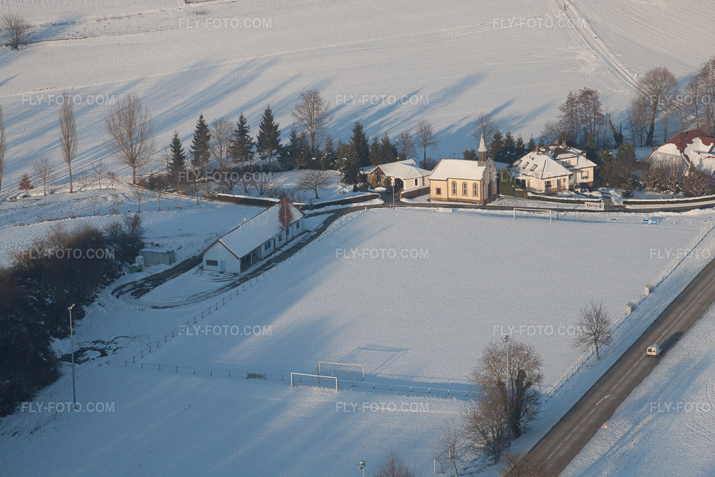Aerial view: Football club with its own chapel in winter when there is snow in Neewiller-près-Lauterbourg in the state Bas-Rhin, France.Photo: IMG_36655.jpg taken on 01/05/2011 by Werner Riehm/FLY-FOTO.comResolution of the original: 4677 x 3118 px