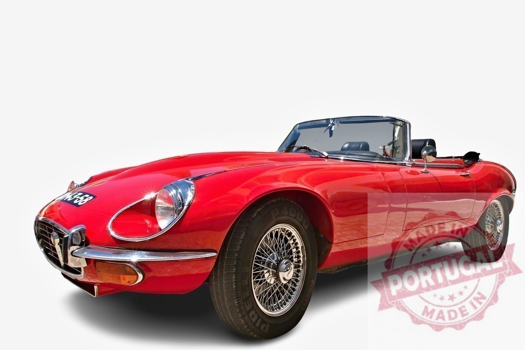 Red Jaguar E-Type Convertible parked, representing british automotive design | Classic red Jaguar E-Type sports car parked with its top down, showcasing timeless automotive design - Realized with Pictrs.com