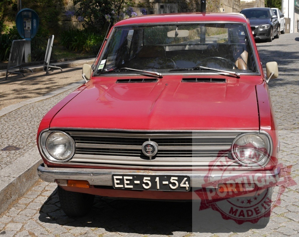Datsun 1200 classic red car on cobblestone street | Red Datsun 1200 vintage automobile parked on a sunny paved street - Realisiert mit Pictrs.com