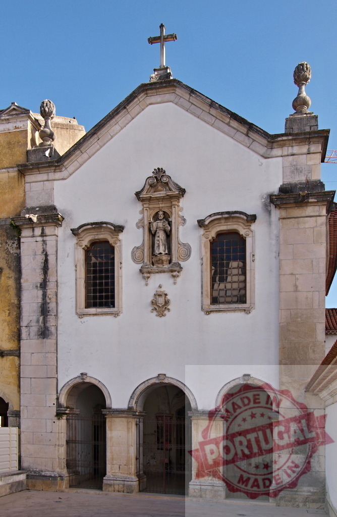 Historic white church facade with saint statue and cross | Portugal historic church facade showcasing religious architecture with a saint statue - Realized with Pictrs.com