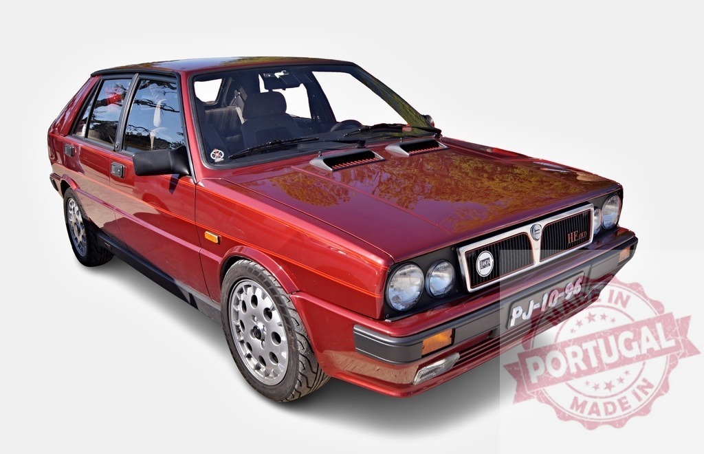 Red Lancia Delta HF HF Integrale classic car | Red Lancia Delta HF Integrale classic car parked on a white background - Realized with Pictrs.com
