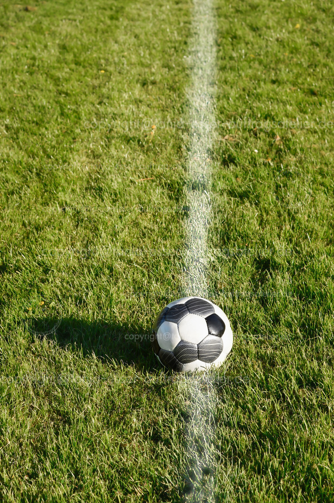 An empty football field in summer | In summer on an empty football field. The grass field has applied lines to limit the playing field. There are no advertisements on the sidelines. Rural area in the Sauerland.