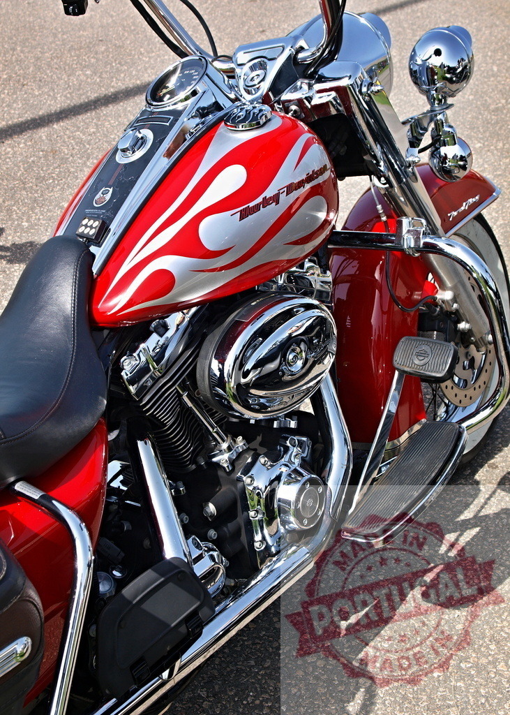 Harley-Davidson motorcycle with custom red flame design | Harley-Davidson cruiser motorcycle featuring a custom red and silver flame paint job and chrome details - Realized with Pictrs.com