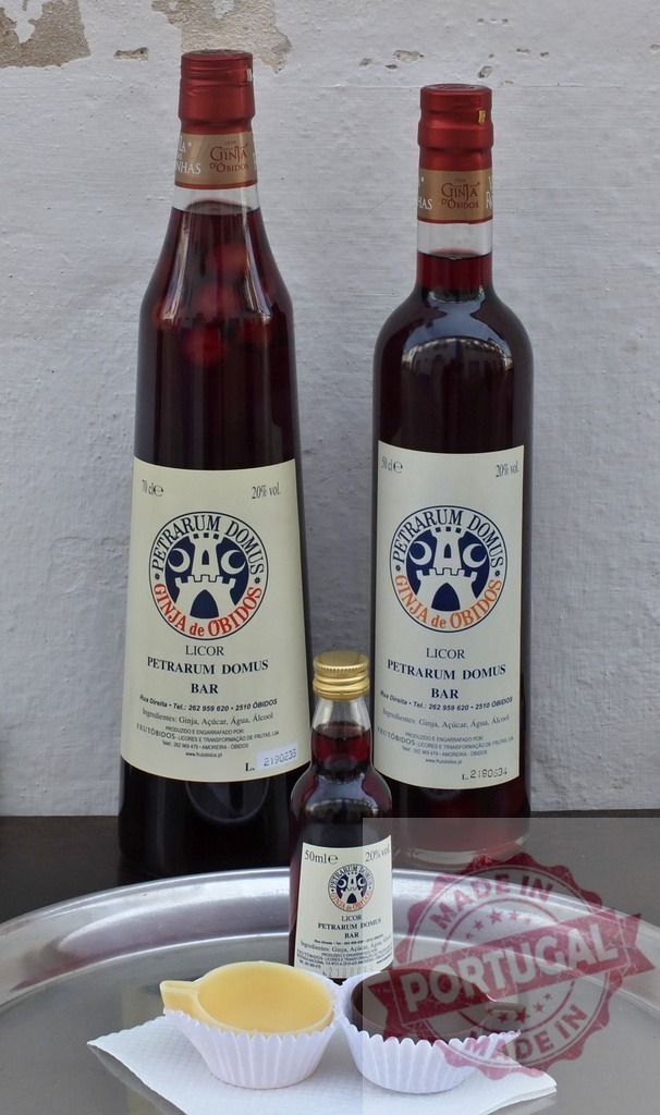 Ginja de Obidos cherry liqueur with chocolate cups | Bottles of traditional Portuguese Ginja liquor served with dark and white chocolate cups - Realized with Pictrs.com
