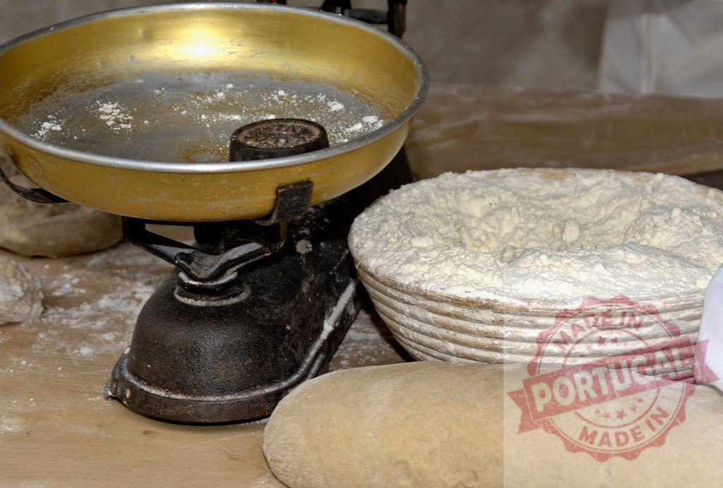 Vintage scale weighing flour and bread dough for baking | Baking ingredients and tools on a rustic wooden table with flour, dough, and a vintage scale - Realized with Pictrs.com