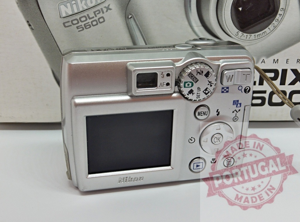 Nikon Coolpix 5600 vintage digital compact camera back view | Nikon Coolpix 5600 digital camera showing screen, buttons, and mode dial - Realized with Pictrs.com