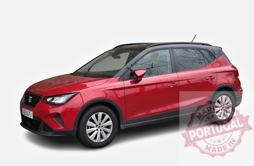 Shiny red SEAT Arona crossover posing in a studio | Studio shot of a red SEAT Arona crossover SUV, showcasing its modern design and vibrant color - Realized with Pictrs.com