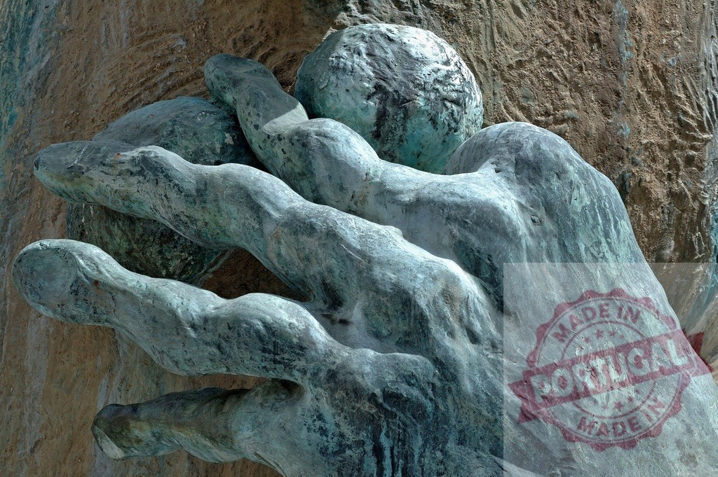Bronze hand grasping a sphere sculpture with texture | Bronze hand sculpture holding a spherical object, showing aged patinated texture - Realized with Pictrs.com