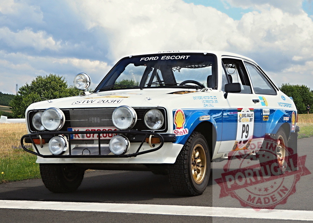 Ford Escort rally car at Eifel Rallye Festival | Vintage Ford Escort rally car parked on asphalt under a cloudy sky - Realized with Pictrs.com