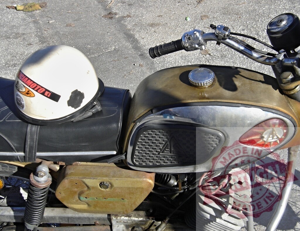 Vintage motorcycle with helmet resting on seat, evoking classic rides | White helmet rests on the seat of a vintage motorcycle, suggesting a nostalgic return to simpler times of open-road adventures - Realized with Pictrs.com