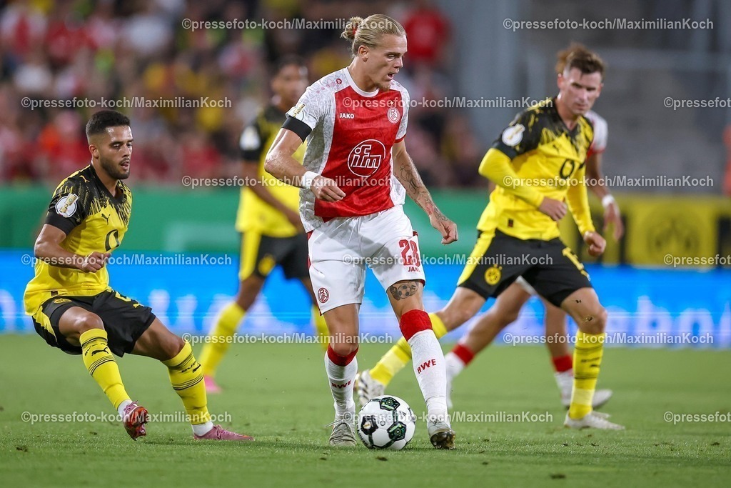 DFB18082501072 | 2025.08.18, Fußball, 1.Runde DFB-Pokal, Rot-Weiss Essen - Borussia Dortmund, Stadion Hafenstraße, Saison 2025 2026: Tom Moustier&nbsp;(Rot-Weiss Essen #28) im Zweikampf gegen  Yan Couto&nbsp;(BVB #02) und Pascal Groß&nbsp;(BVB #13)   DFB regulations prohibit any use of photographs as image sequences and or quasi-video.