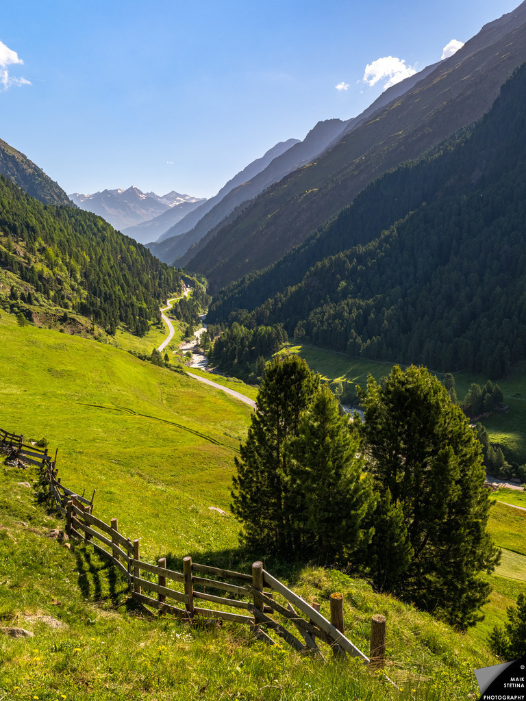 The First Ascent to Breslauer Hut | I began this multi-day birthday hike in the Austrian Alps with the summer heatwave building far below me, grateful for the cooler mountain air above Vent. After leaving my car at the chairlift station, I had barely climbed the first hundred meters when the valley opened toward the northeast. From the green pastures in front of me, my eyes followed the winding valley road and river into the distance, all the way to the rising peaks of the Stubai Alps. Ahead of me were still 1,000 meters of ascent to the Breslauer Hut, but in this quiet moment I felt both the weight of the journey and the deep joy of starting it. - Realisiert mit Pictrs.com