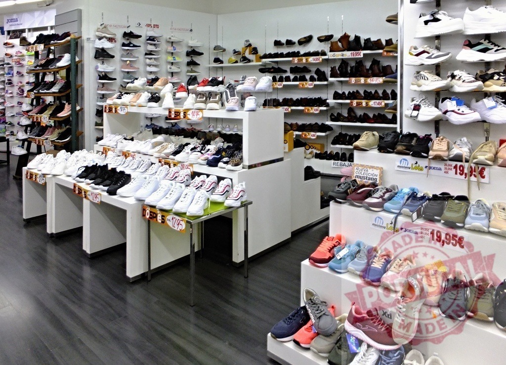 Footwear store displaying various shoes for sale | Shoe store interior showing numerous sneakers and casual footwear on racks and displays - Realized with Pictrs.com