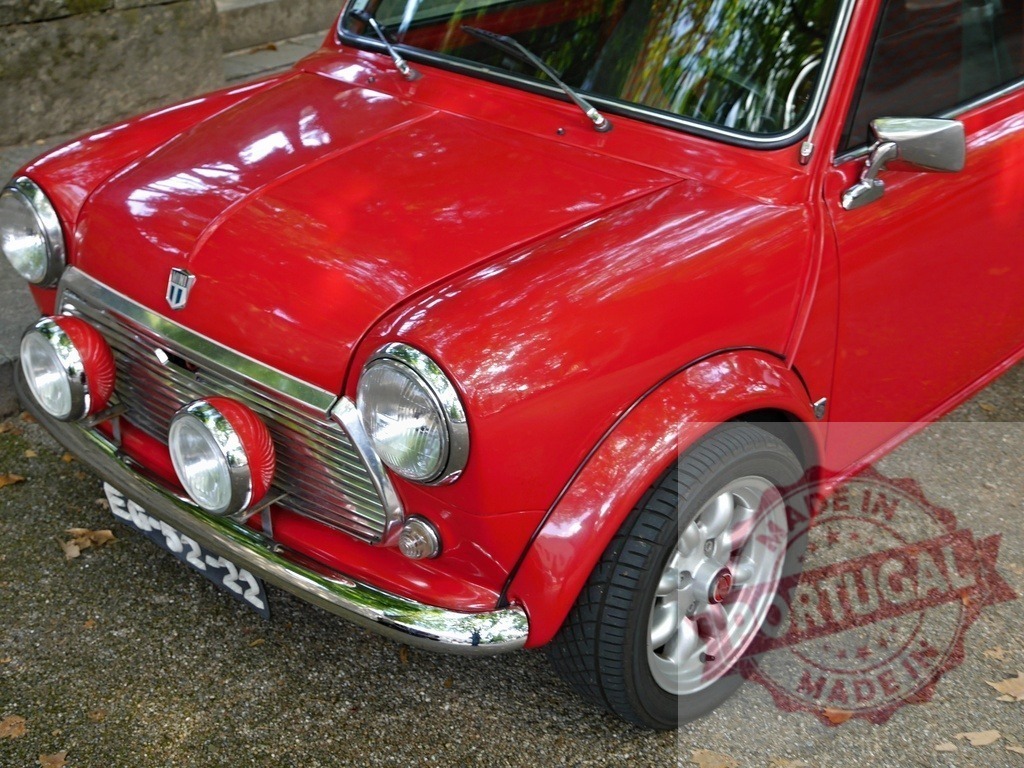 Red vintage Mini Cooper car parked outdoors | Red classic Mini Cooper car parked on a gravel surface outdoors - Realized with Pictrs.com